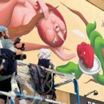 Lo street artist Zed1 al lavoro all'eco murale Mela Mundi