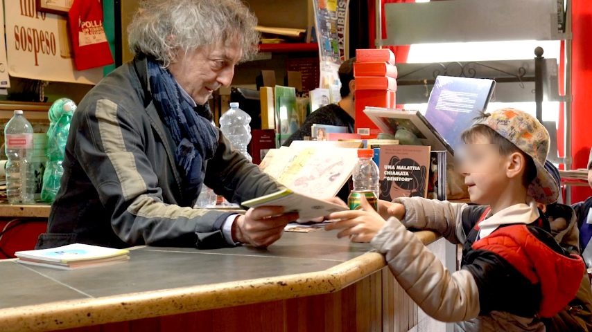 Michele Gentile nella sua libreria di Polla, con un piccolo lettore