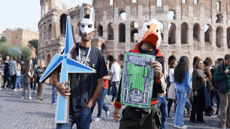 Due attivisti mascherati lanciano l'evento del Climate Pride sotto il Colosseo